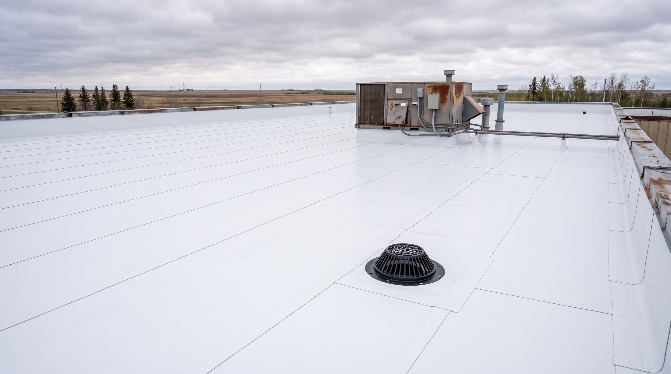 The same roof after replacement with a new white membrane